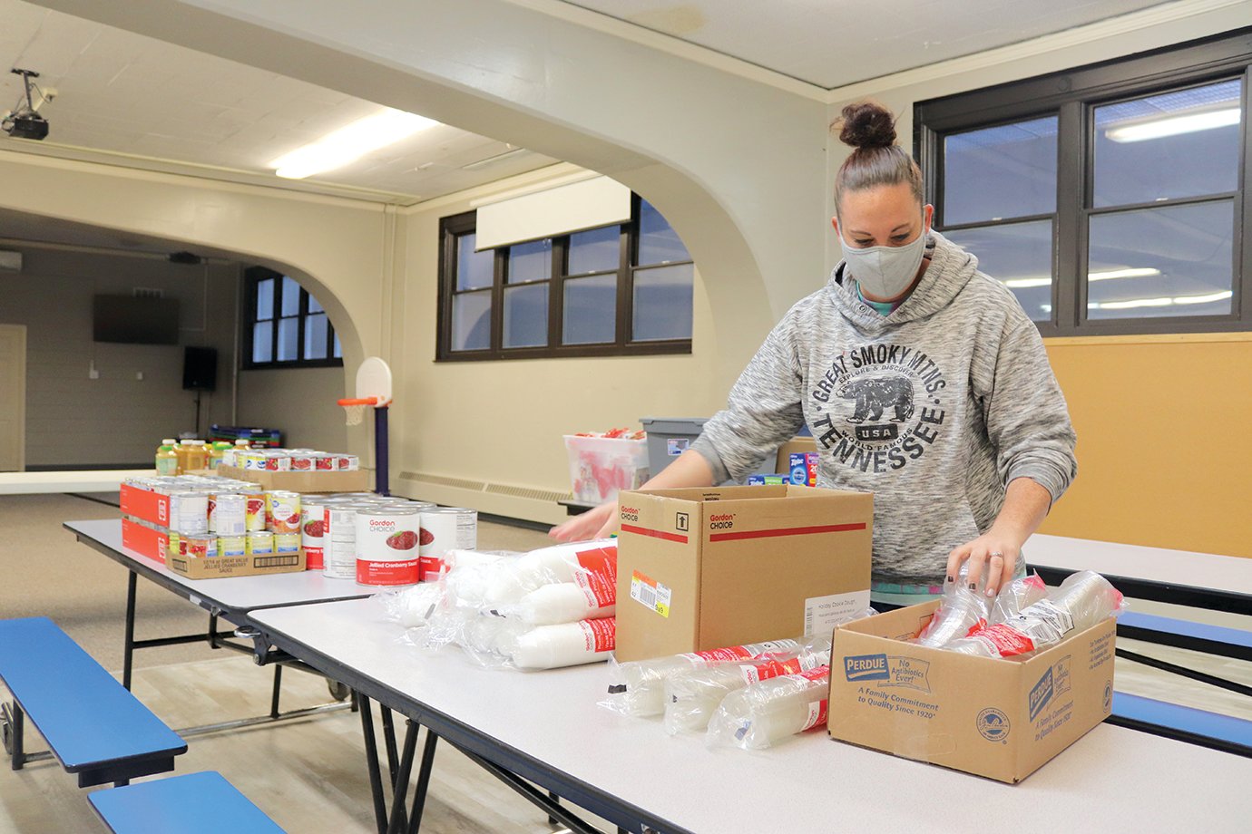 Andrea Posthauer works to organize paper and plastic products Wednesday at First United Methodist ahead of Thursday's Thanksgiving Community Dinner.
